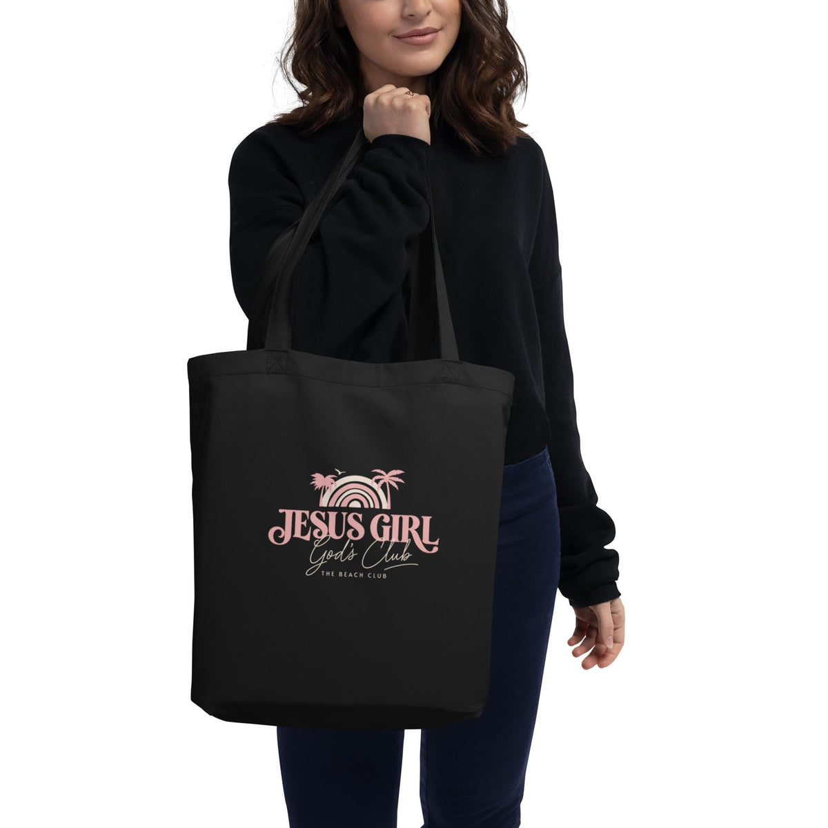 Woman carrying the black Jesus Girl organic cotton Christian tote bag